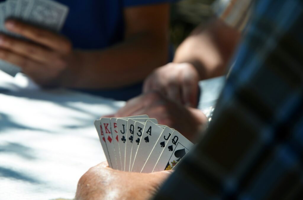 person holding playing cards