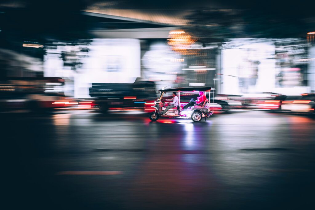 blurred image of person being driven in a tuk tuk like vehicle