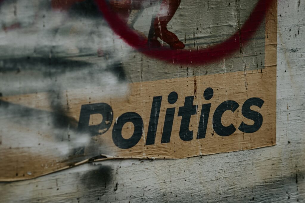 carboard sign with internal politics written on it, the internal part is cropped out